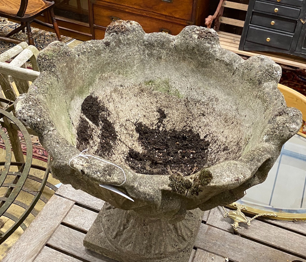 A pair reconstituted stone garden urns mounted with stylised leaves